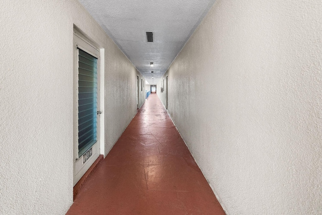 hallway featuring a textured ceiling