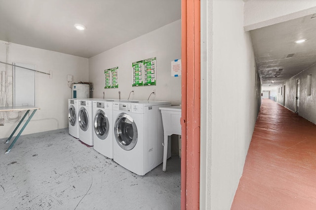 laundry room featuring water heater and washing machine and dryer