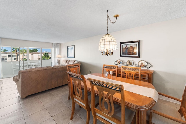 dining area featuring a textured ceiling and light tile patterned floors