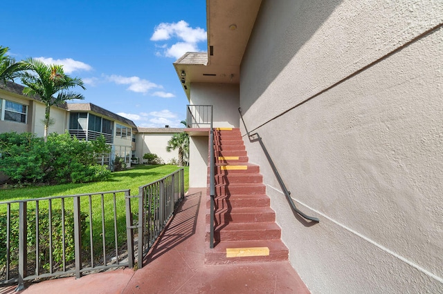 view of exterior entry featuring a yard