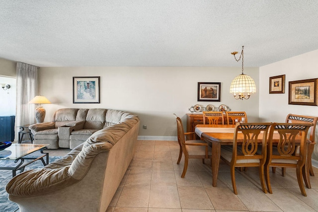 tiled dining room featuring a textured ceiling