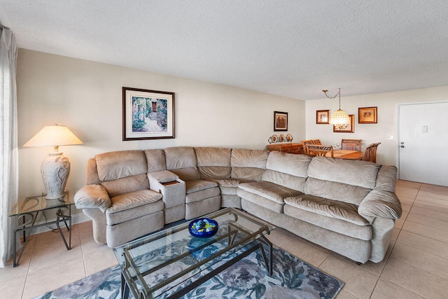 living room with a textured ceiling and light tile patterned flooring