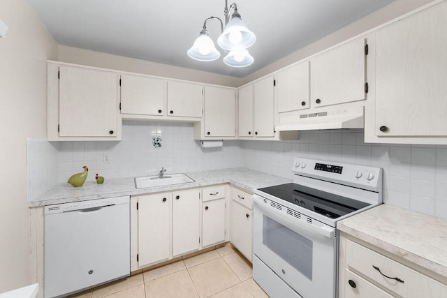 kitchen with sink, white appliances, backsplash, light tile patterned floors, and decorative light fixtures