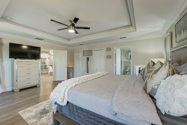 bedroom featuring a raised ceiling, crown molding, and ceiling fan