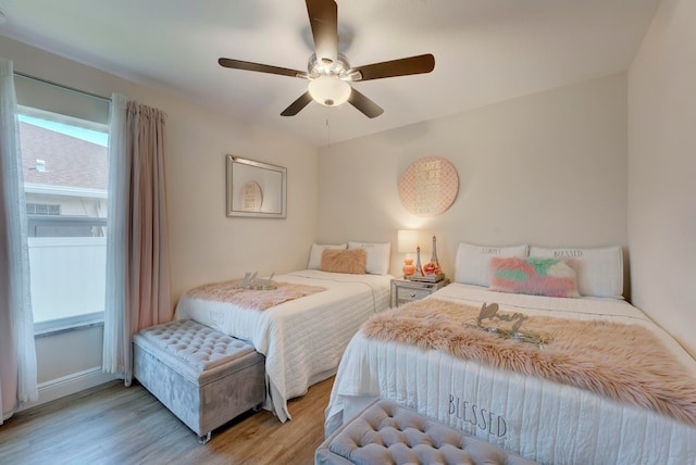 bedroom with light hardwood / wood-style floors and ceiling fan