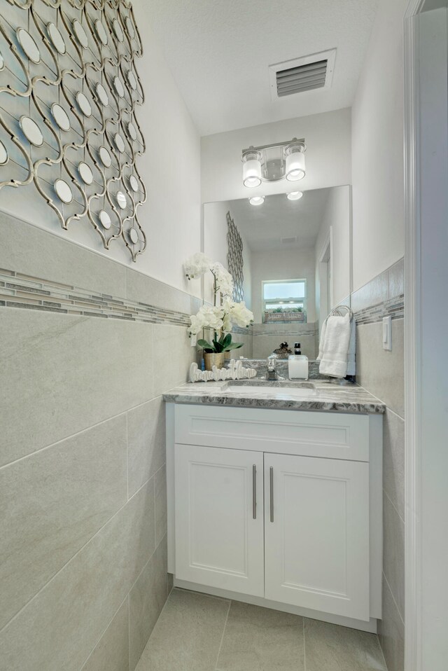 bathroom with vanity, tile walls, and tile patterned floors