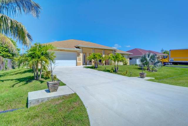 view of front of home with a front yard and a garage