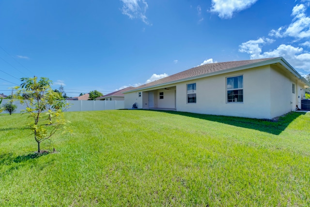 rear view of house with a yard