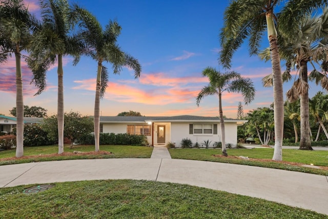 ranch-style house with a yard