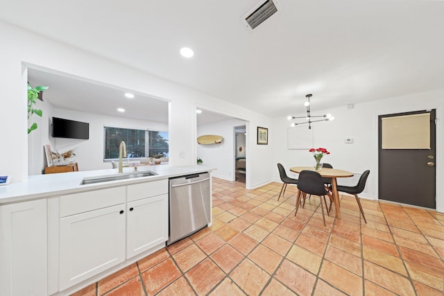 kitchen with dishwasher, white cabinetry, and sink