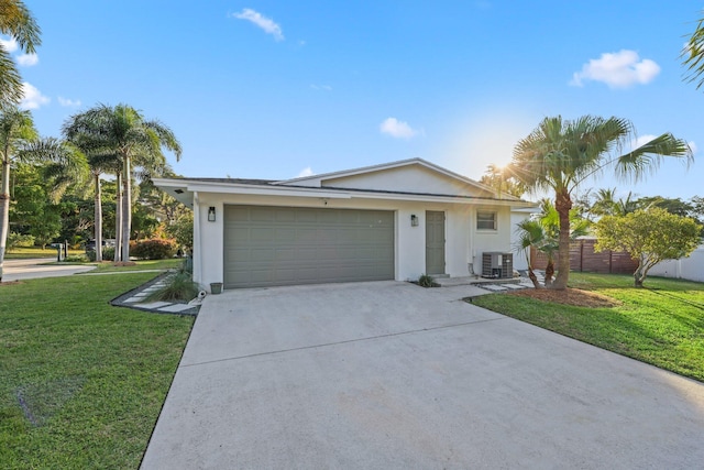 single story home with a front lawn, a garage, and central AC