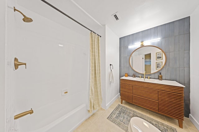 full bathroom with vanity, tile patterned flooring, toilet, tile walls, and shower / tub combo with curtain