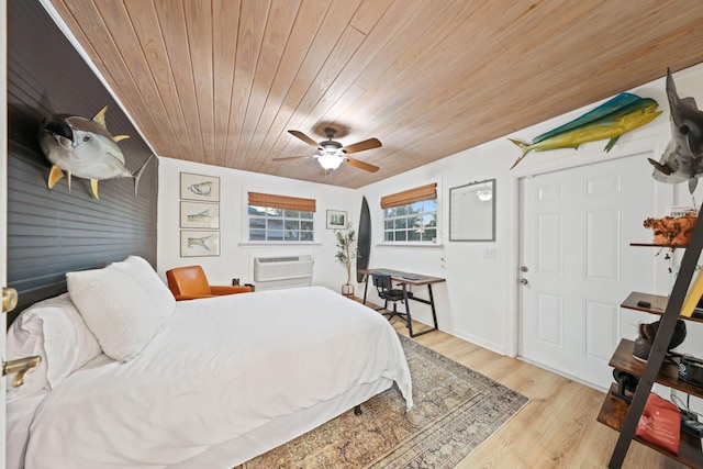 bedroom featuring ceiling fan, light hardwood / wood-style floors, wood ceiling, and an AC wall unit