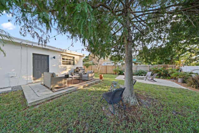 view of yard featuring a patio area and an outdoor living space with a fire pit