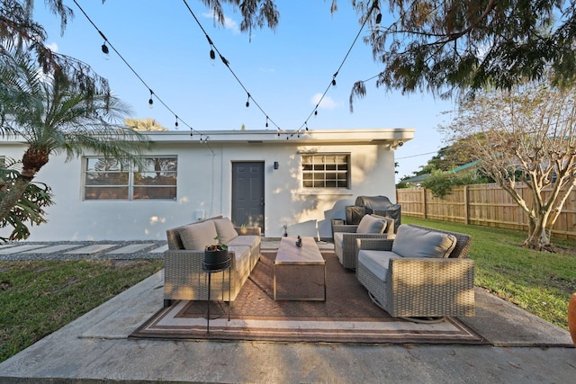 back of house with a lawn, outdoor lounge area, and a patio