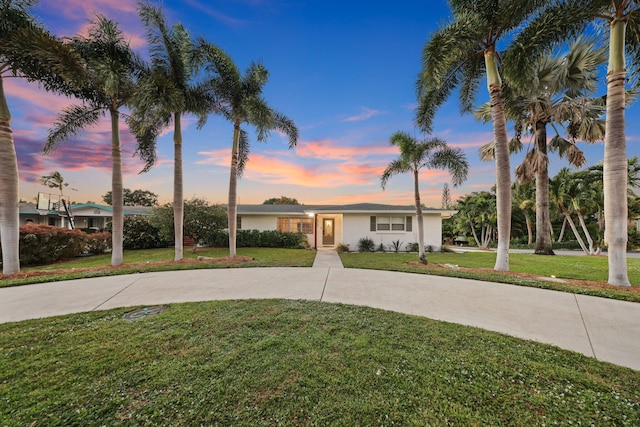 ranch-style house with a lawn