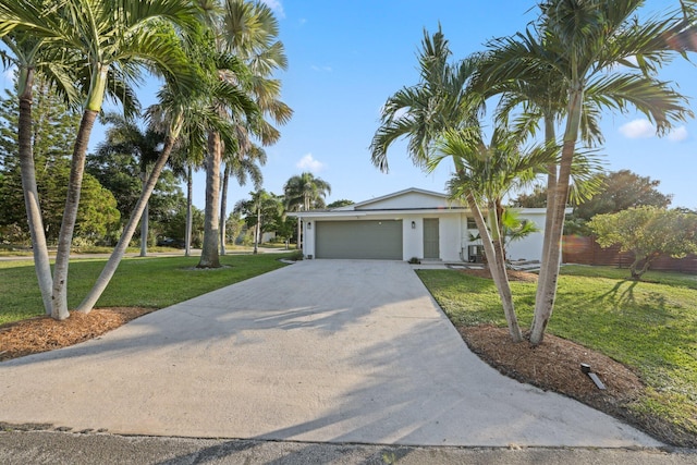 view of front of home with a front yard and a garage