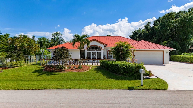 view of front of home featuring a garage and a front yard