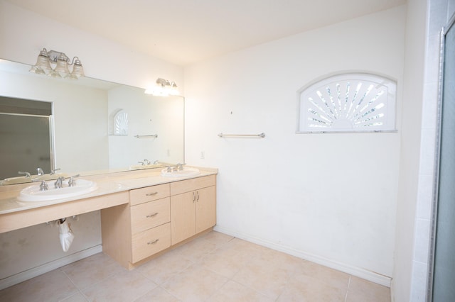 bathroom featuring tile patterned flooring, walk in shower, and sink