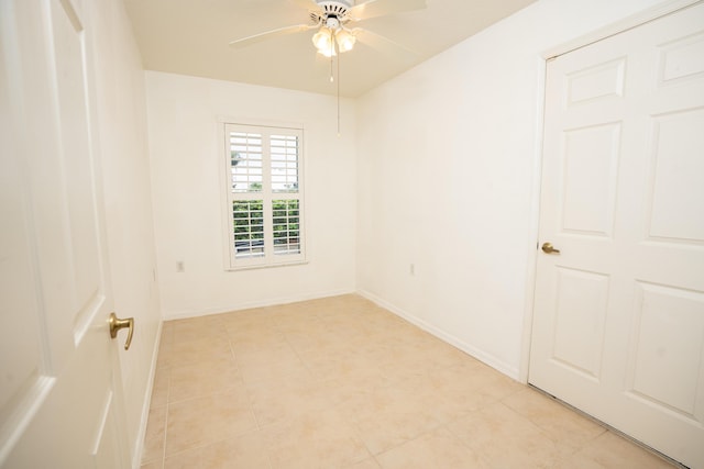 empty room featuring light tile patterned floors and ceiling fan