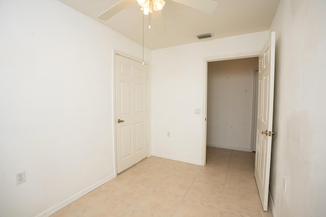 unfurnished bedroom with ceiling fan and light tile patterned floors