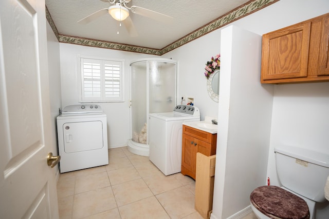 washroom featuring a textured ceiling, washer and clothes dryer, ceiling fan, sink, and light tile patterned flooring