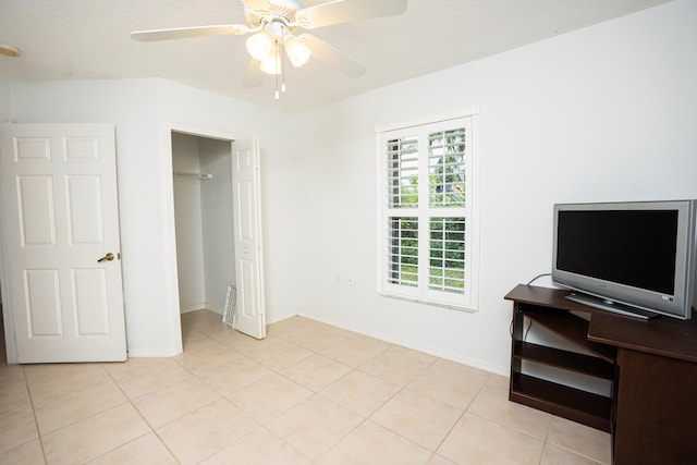 bedroom featuring a closet, ceiling fan, and light tile patterned flooring