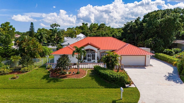 view of front of house with a garage and a front lawn