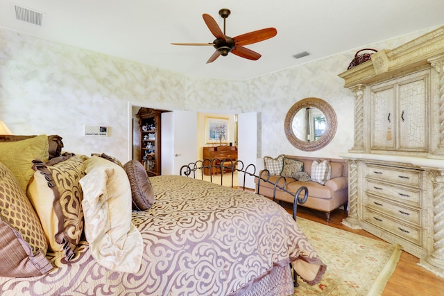 bedroom with light hardwood / wood-style flooring and ceiling fan