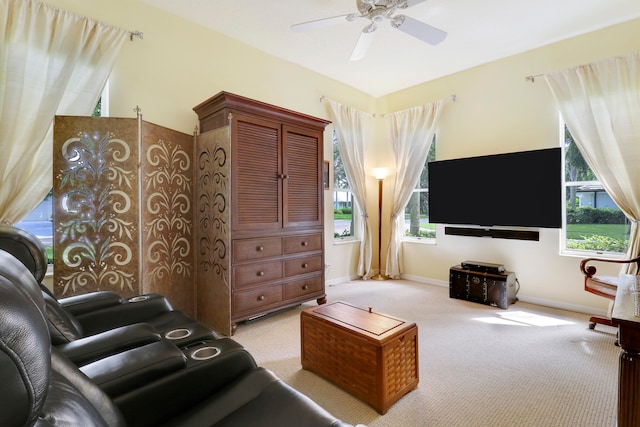 carpeted living room featuring ceiling fan and a healthy amount of sunlight