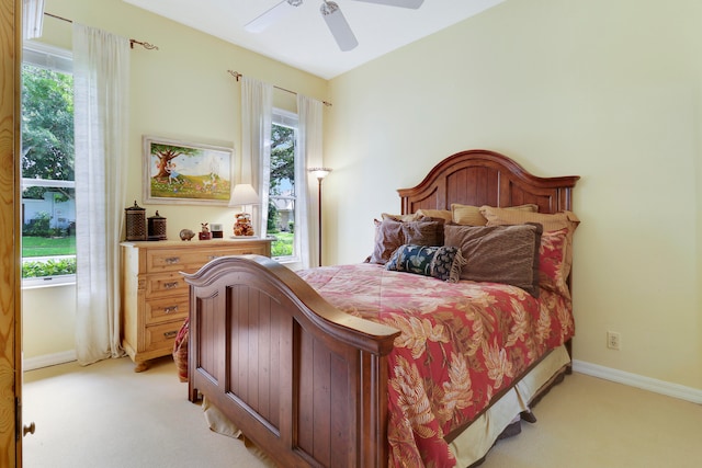 bedroom with light carpet and ceiling fan