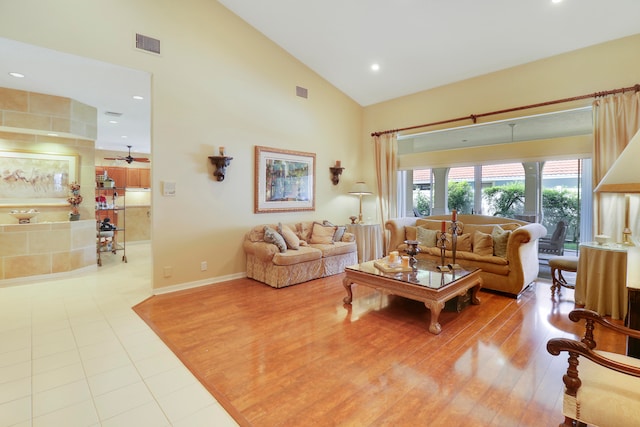 living room featuring high vaulted ceiling, light wood-type flooring, and ceiling fan