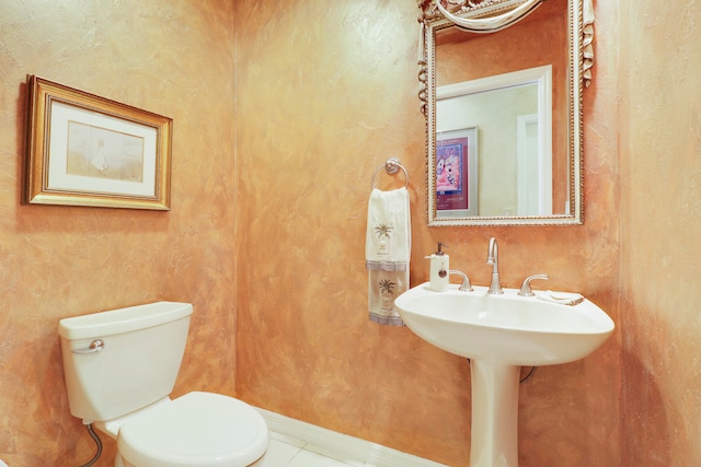 bathroom with tile patterned flooring and toilet