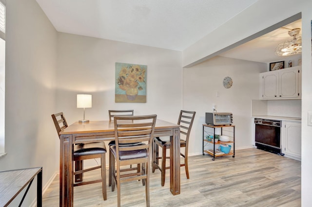 dining space with light hardwood / wood-style flooring