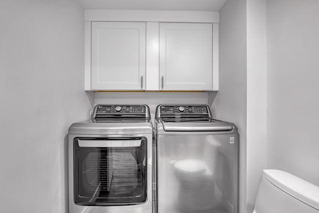 laundry area featuring cabinets and washing machine and dryer