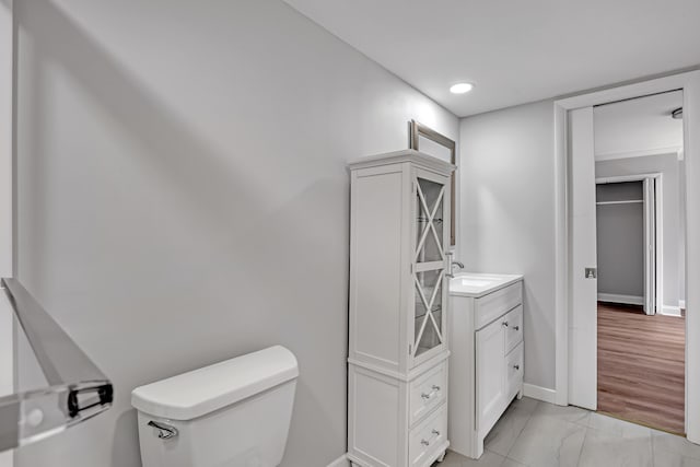 bathroom featuring vanity, toilet, and wood-type flooring