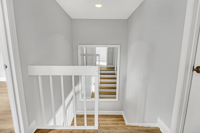 stairs featuring hardwood / wood-style flooring