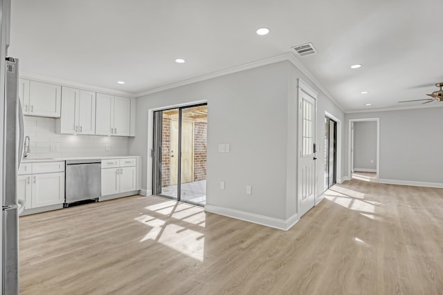 kitchen featuring white cabinetry, backsplash, crown molding, appliances with stainless steel finishes, and light wood-type flooring