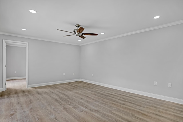 empty room featuring light hardwood / wood-style flooring, ceiling fan, and crown molding