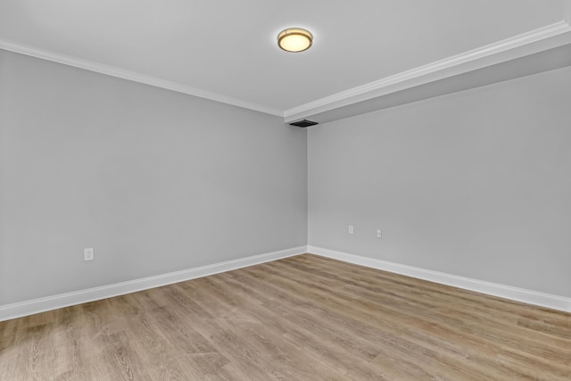 empty room with light wood-type flooring and ornamental molding