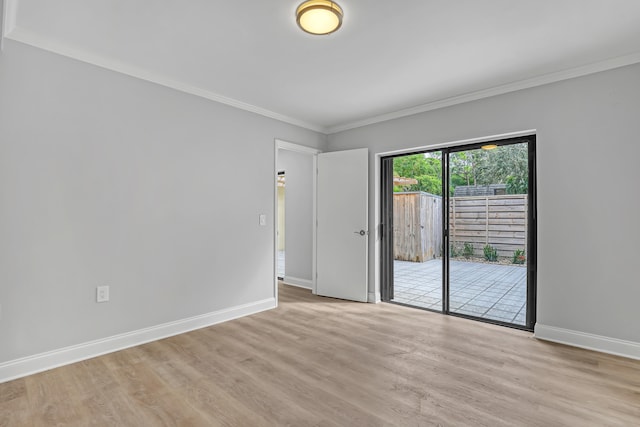 empty room featuring light hardwood / wood-style floors and ornamental molding