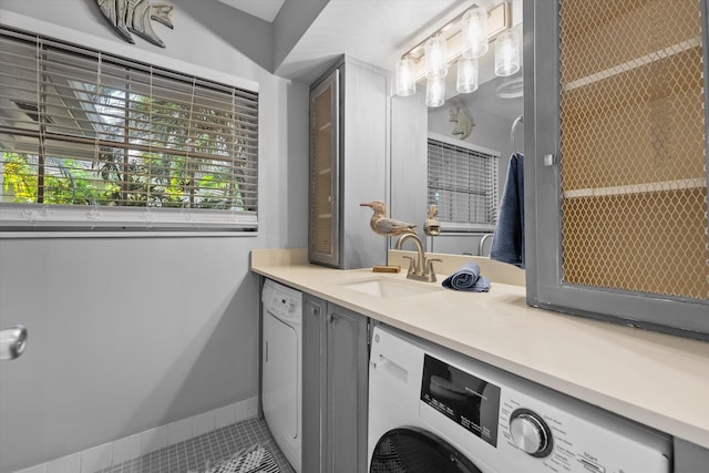 bathroom featuring vanity, washer / clothes dryer, and tile patterned floors