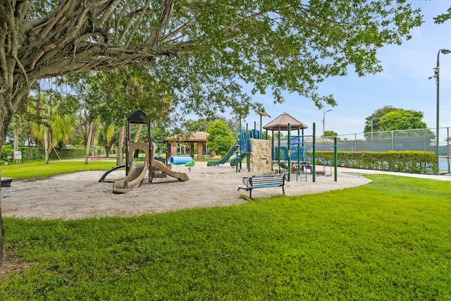 view of playground featuring a water view and a yard