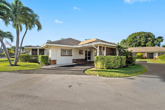 ranch-style home with a front lawn