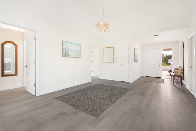 entrance foyer featuring dark hardwood / wood-style floors and an inviting chandelier