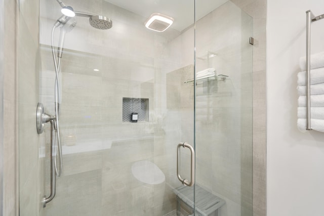 bathroom with a shower with shower door