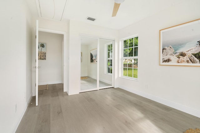 unfurnished room featuring ceiling fan and light hardwood / wood-style flooring