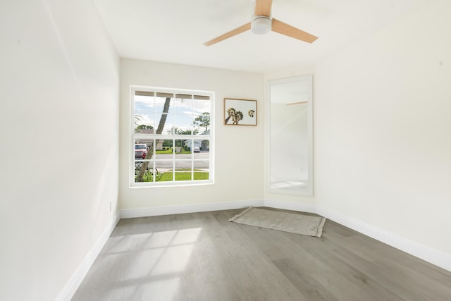 empty room with light hardwood / wood-style flooring and ceiling fan