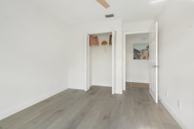 interior space with ceiling fan, a closet, and light hardwood / wood-style floors