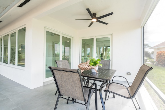 sunroom with plenty of natural light and ceiling fan